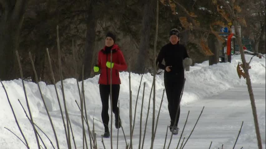 Two women run on the trail around Lake of the Isles on Friday, Feb. 24, 2023, in Minneapolis.
